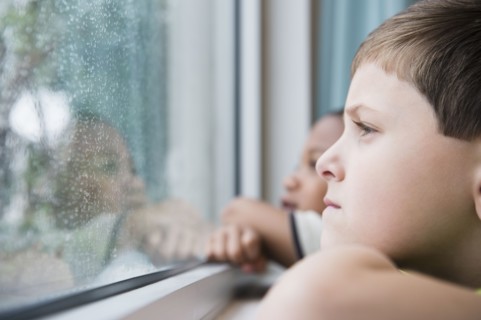 Boys looking out window together