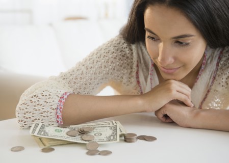 Hispanic teenager looking at money