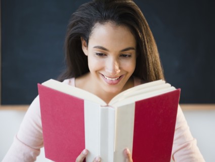 Hispanic teenager reading book
