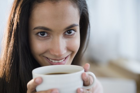 Hispanic teenager drinking coffee