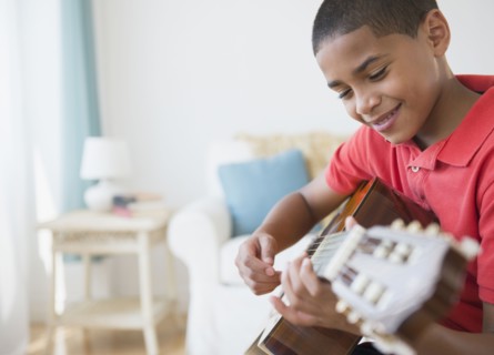 Hispanic boy playing guitar