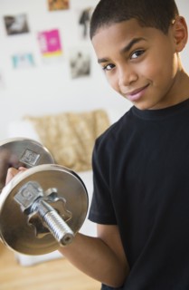 Hispanic boy lifting weights