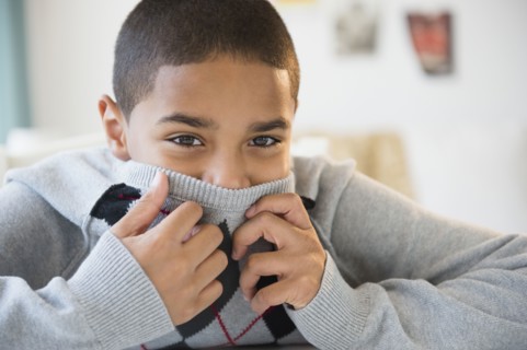 Hispanic boy hiding his face