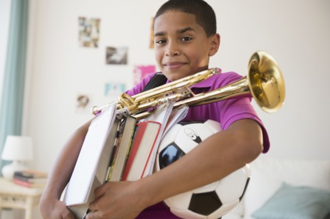 Hispanic boy carrying trumpet