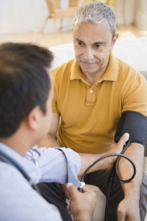 Hispanic man having his blood pressure taken