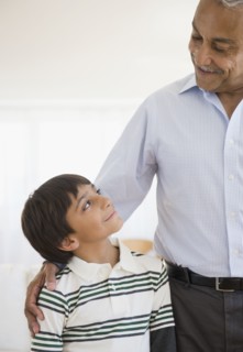 Hispanic grandfather smiling at grandson