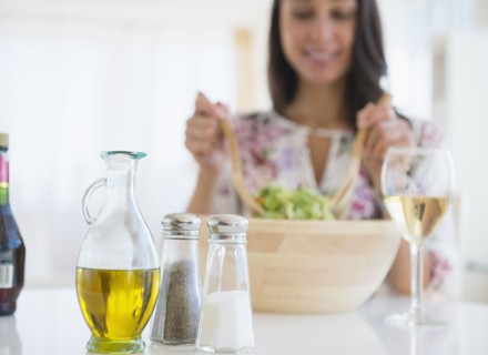 Caucasian woman tossing salad at lunch