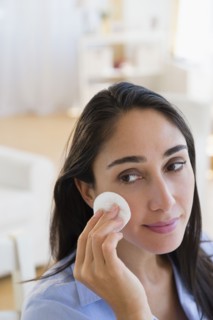 Caucasian businesswoman wiping her face