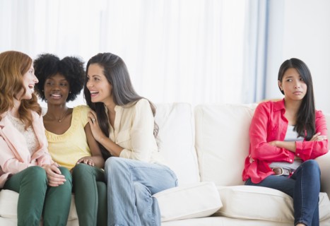 Woman excluded from conversation on sofa