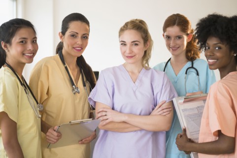 Nurses in colorful scrubs talking in hospital