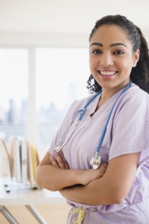 Hispanic nurse smiling in hospital