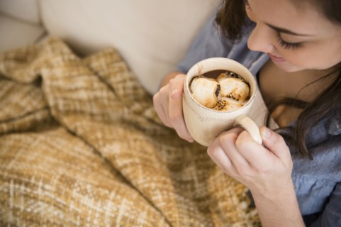 Hispanic girl drinking hot chocolate