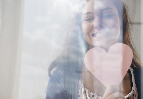 Hispanic girl holding heart