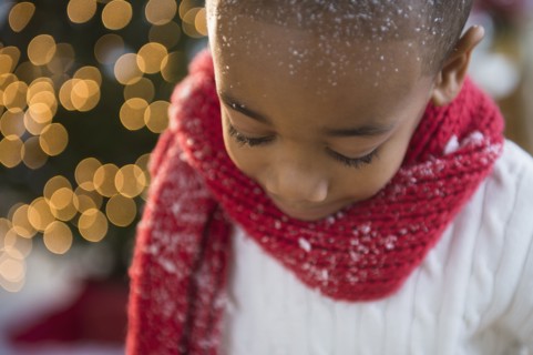 African American boy wearing scarf in snow