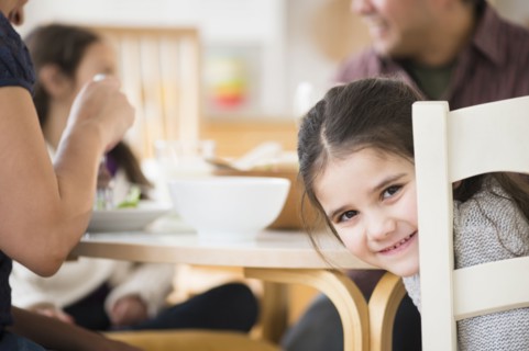 Smiling girl sitting at table