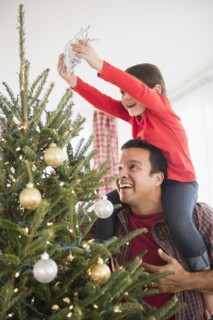 Father and daughter decorating Christmas tree