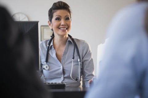 Doctor talking to clients in office