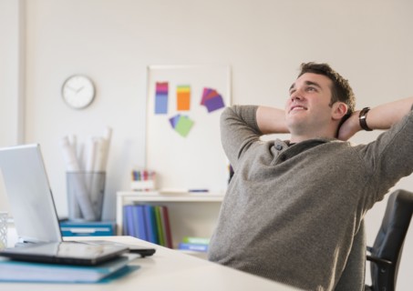 Businessman relaxing at desk in office