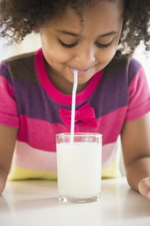 African American girl drinking glass of milk