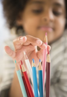African American girl picking out colored pencil