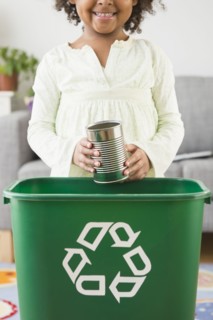 African American girl recycling can