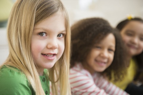 Smiling girls sitting in line
