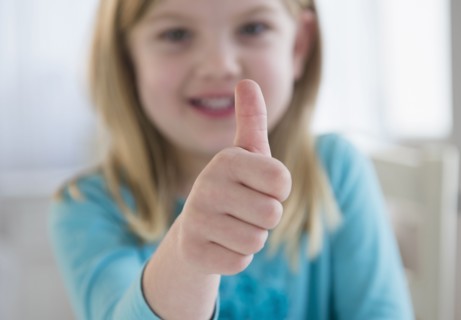 Caucasian girl giving thumbs-up