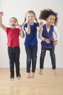 Girls jumping for joy together