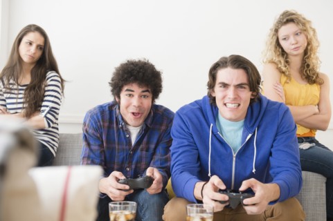Men with video games ignoring girlfriends