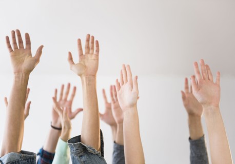 People's hands raised in air