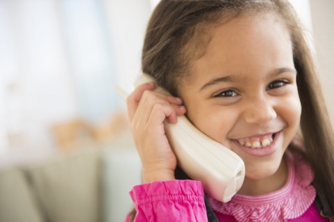 Hispanic girl talking on telephone