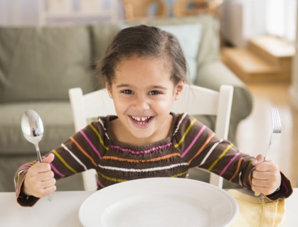 Hispanic girl demanding food at table