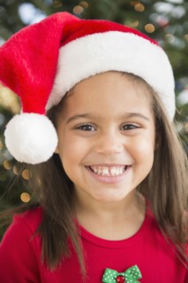 Hispanic girl wearing Santa hat