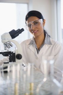 Indian scientist using microscope in lab