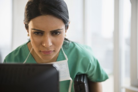 Indian nurse using laptop in office