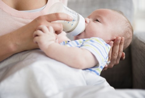Caucasian mother bottle feeding baby