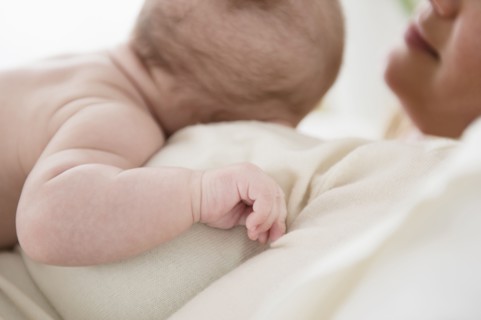 Caucasian mother kissing baby