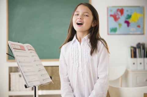 Mixed race girl in singing class