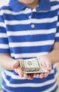 Hispanic boy holding money