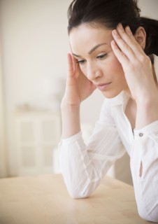 Caucasian woman rubbing her temples