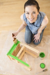 Caucasian woman painting stool