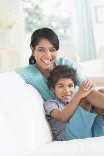 Mother and son relaxing on sofa