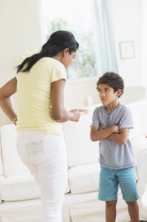 Mother scolding son in living room