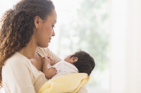 Hispanic mother holding newborn baby