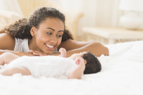 Hispanic mother admiring baby
