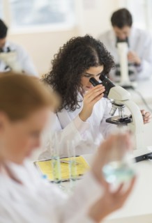 Scientist using microscope in laboratory