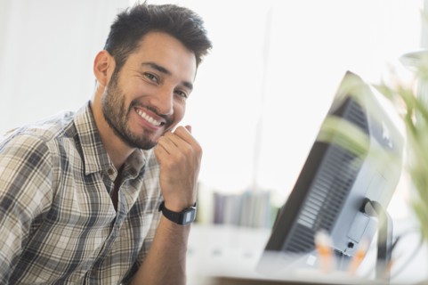 Mixed race businessman smiling in office