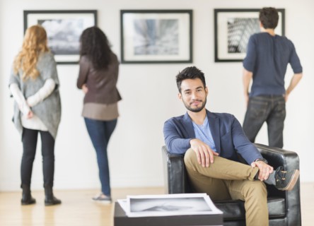 Artist smiling in art gallery
