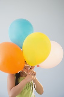 Korean girl hiding behind bunch of balloons