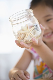 Korean girl examining starfish in jar